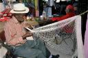 Cayman fisherman making a net by Cayman Islands Tourism